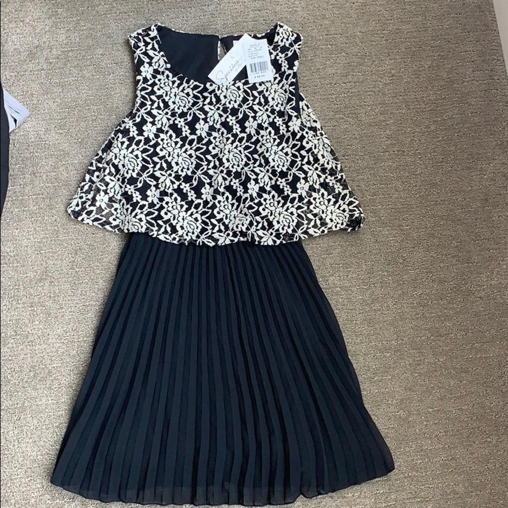 Black and white pleated dress with lace bodice